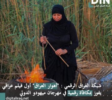 Woman in black hijab tending a small fire in a reed filled outdoor area, holding wooden sticks 